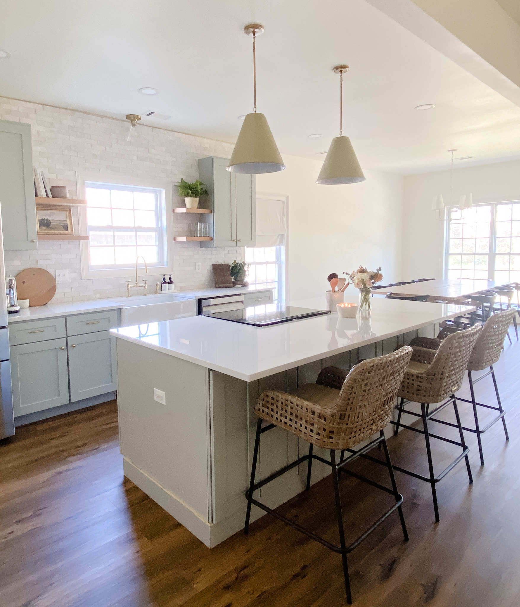 Kitchen renovation with island, wood floors and clay tile backsplash